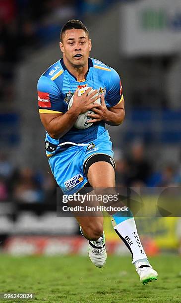 Jarryd Hayne of the Titans runs the ball during the round 25 NRL match between the Gold Coast Titans and the Penrith Panthers at Cbus Super Stadium...