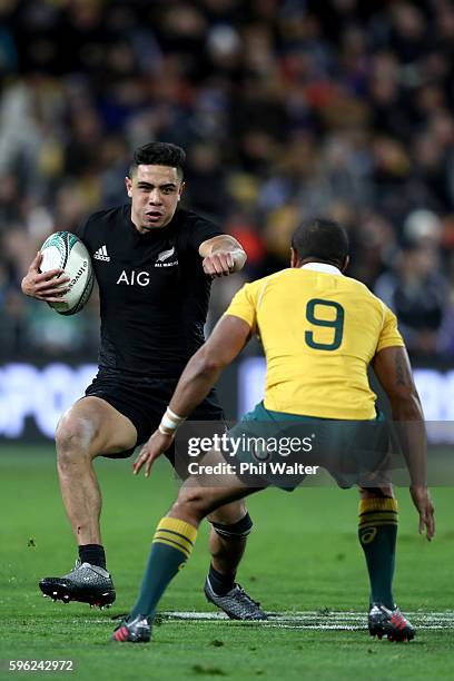 Anton Lienert-Brown fends off Will Genia of Australia during the Bledisloe Cup Rugby Championship match between the New Zealand All Blacks and the...