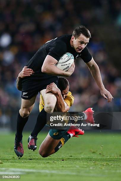 Ben Smith of New Zealand is tackled by Quade Cooper of Australia during the Bledisloe Cup Rugby Championship match between the New Zealand All Blacks...