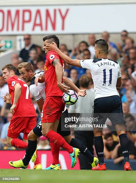 Tottenham Hotspur's Argentinian midfielder Erik Lamela grabs Liverpool's Croatian defender Dejan Lovren in the face during the English Premier League...