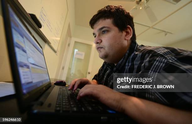 Analyst Corey Weiss, who was disgnosed with autism as a young boy, works at Mindspark on August 24, 2016 in Santa Monica, California. - About one...