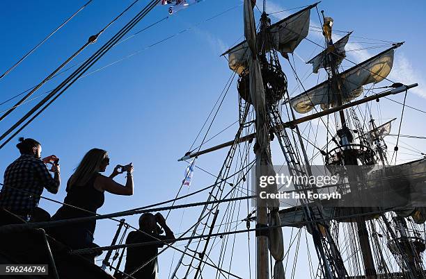 Visitors take pictures during a visit to one of the ships moored at the quayside during the North Sea Tall Ships Regatta on August 27, 2016 in Blyth,...