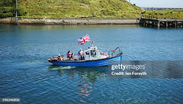 Small pleasure cruiser sails along the River Blyth during the North Sea Tall Ships Regatta on August 27, 2016 in Blyth, England. The bustling port...
