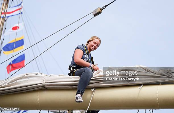 Crew member sits high in the rigging as she repairs a sail during the North Sea Tall Ships Regatta on August 27, 2016 in Blyth, England. The bustling...
