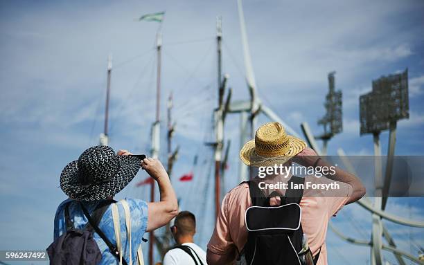 Couple stop to look at the tall ships during the North Sea Tall Ships Regatta on August 27, 2016 in Blyth, England. The bustling port town in South...