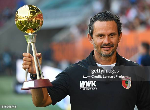 Dirk Schuster, head coach of FC Augsburg is awarded as 'coach of the year' by magazine Kicker prior to the Bundesliga match between FC Augsburg and...