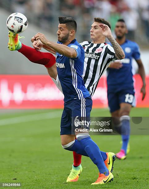 Sead Kolasinac of Schalke is challenged by Guillermo Varela of Frankfurt during the Bundesliga match between Eintracht Frankfurt and FC Schalke 04 at...