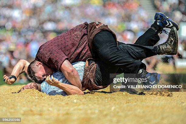Athlete Beat Wickli fight against Christian Stucki during the first day of the Federal Alpine Wrestling Festival on August 27, 2016 in Payerne,...