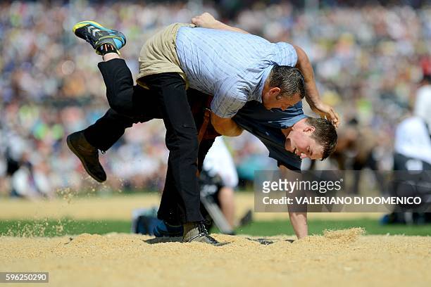 Athlete Arnold Forrer fight against Alex Schuler during the first day of the Federal Alpine Wrestling Festival on August 27, 2016 in Payerne, western...