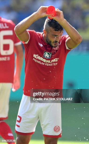 Mainz' Italian defender Giulio Donati refreshes during the German first division Bundesliga football match of Borussia Dortmund vs FSV Mainz 05 in...