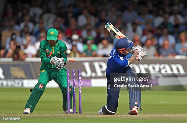 Alex Hales of England is bowled as Pakistan wicket keeper Sarfraz Ahmed looks on during the 2nd One Day International at Lord's Cricket Ground on...