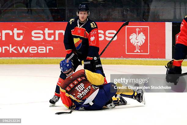 Alexander Falk of Djurgarden Stockholm topples Dario Simion of HC Davos during the third period of the Champions Hockey League match between...
