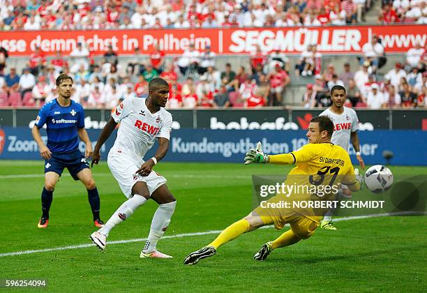 Cologne's French forward Anthony Modeste scores the 2-0 against Darmstadt's goalkeeper Michael Esser during the German first division Bundesliga...