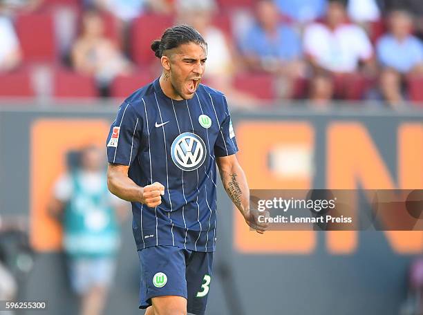 Ricardo Rodriguez of VfL Wolfsburg celebrates his team's second goal during the Bundesliga match between FC Augsburg and VfL Wolfsburg at WWK Arena...