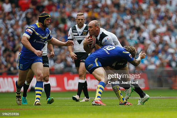 Gareth Ellis of Hull FC tries to break through a tackle by Ashton Sims of Warrington Wolves during the Ladbrokes Challenge Cup Final between Hull FC...