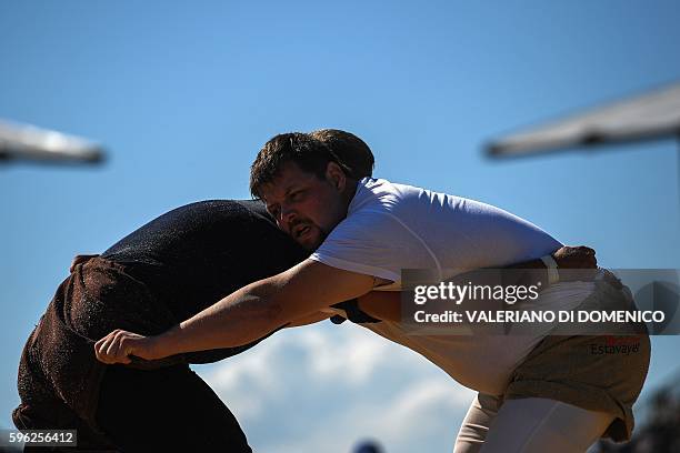 Athletes wrestle during the first day of the Federal Alpine Wrestling Festival on August 27, 2016 in Payerne, western Switzerland. The Federal Alpine...