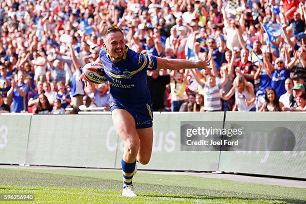 Ben Currie of Warrington Wolves celebrates after scoring a try during the Ladbrokes Challenge Cup Final between Hull FC and Warrington Wolves at...