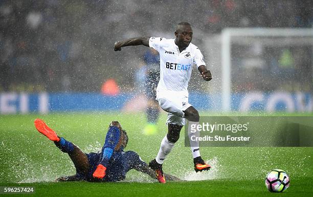 Modou Barrow of Swansea City skips past Ahmed Musa of Leicester City during the Premier League match between Leicester City and Swansea City at The...