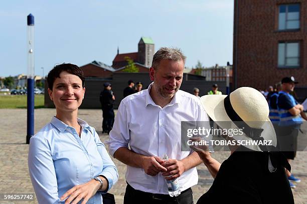 Leif-Erik Holm , top candidate for regional elections of the Alternative for Germany party, talks with a woman as AfD party chairwoman Frauke Petry...