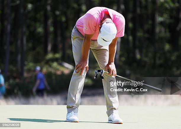 Adam Scott of Australia reacts to a missed eagle putt on the fourth green during the third round of The Barclays in the PGA Tour FedExCup Play-Offs...