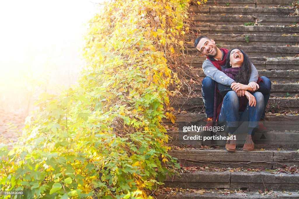 Young people sitting on stairs and having fun