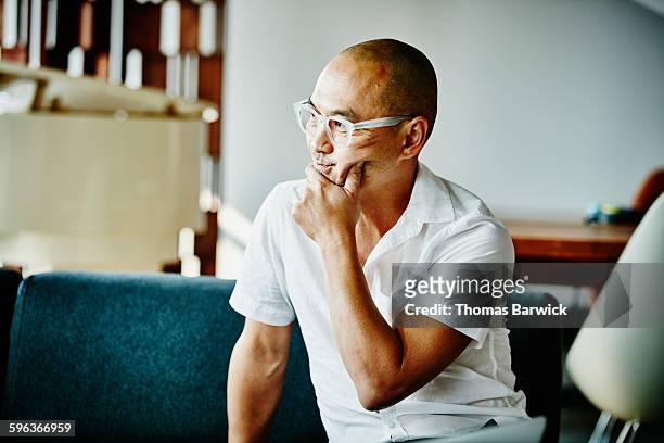 businessman with hand on chin listening - selective focus foto e immagini stock