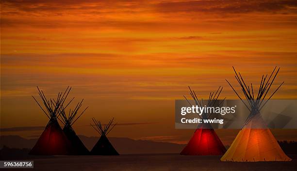 teepee camp and gold, dark, sunset- light in teepees - teepee stock pictures, royalty-free photos & images