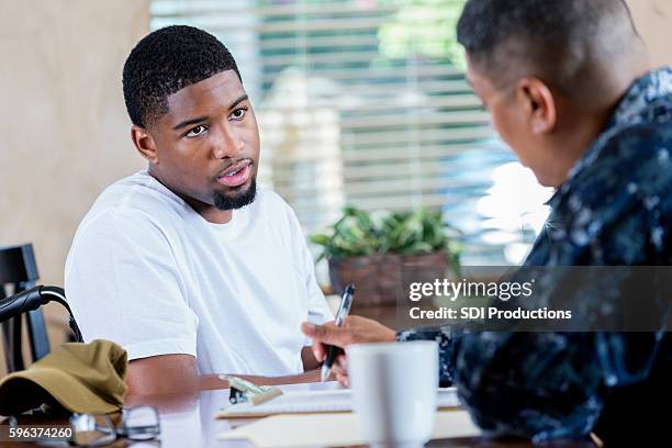 young injured soldier talking to veteran's counselor or doctor - injured us army stock pictures, royalty-free photos & images