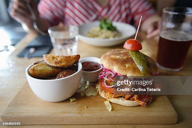 pulled pork burger in a restaurant - eating pulled pork stock pictures, royalty-free photos & images