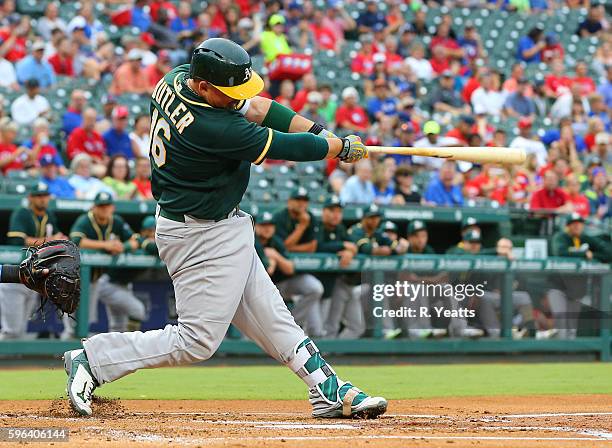 Billy Butler of the Oakland Athletics hits in the first inning against the Texas Rangers at Globe Life Park in Arlington on August 16, 2016 in...