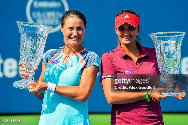Sania Mirza of India and Monica Niculescu of Romania pose for photos after defeating Kateryna Bondarenko of the Ukraine and Chia-Jung Chuang of...