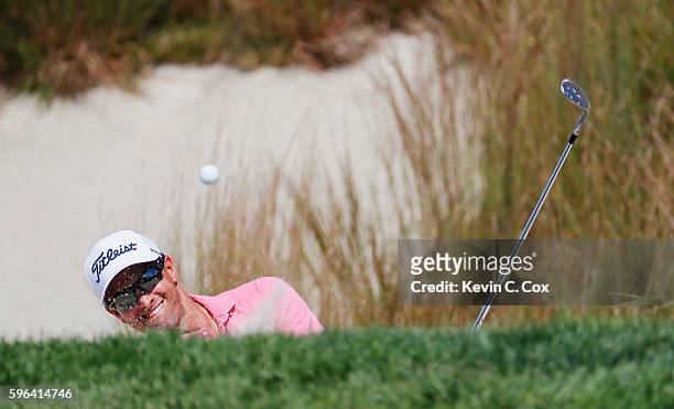 Adam Scott of Australia plays a bunker shot on the 16th hole during the third round of The Barclays in the PGA Tour FedExCup Play-Offs on the Black...