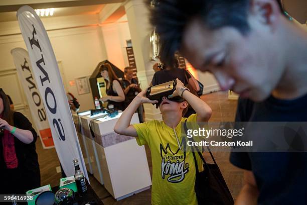Visitor tests the 360 view on the Getty Images stand during the EyeEm photofestival at Heimathafen Neukoelln on August 27, 2016 in Berlin, Germany.