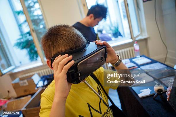 Visitor tests the 360 view on the Getty Images stand during the EyeEm photofestival at Heimathafen Neukoelln on August 27, 2016 in Berlin, Germany.