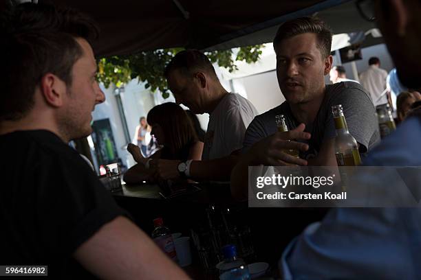 Visitors attend the EyeEm photofestival at Heimathafen Neukoelln on August 27, 2016 in Berlin, Germany.