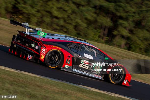The Lamborghini Huracan GT3 of Bryan Sellers and Madison Snow races on the track during practice for the IMSA WeatherTech Series race at Virginia...