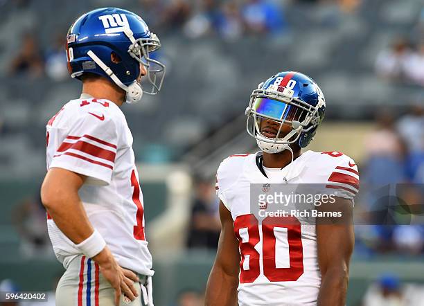 Eli Manning and Victor Cruz of the New York Giants talk prior to the tart of a preseason game against the New York Jets at MetLife Stadium on August...