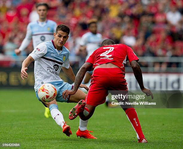 Ashley Westwood of Aston Villa is challenged by Mark Little of Bristol City during the Sky Bet Championship match between Bristol City and Aston...