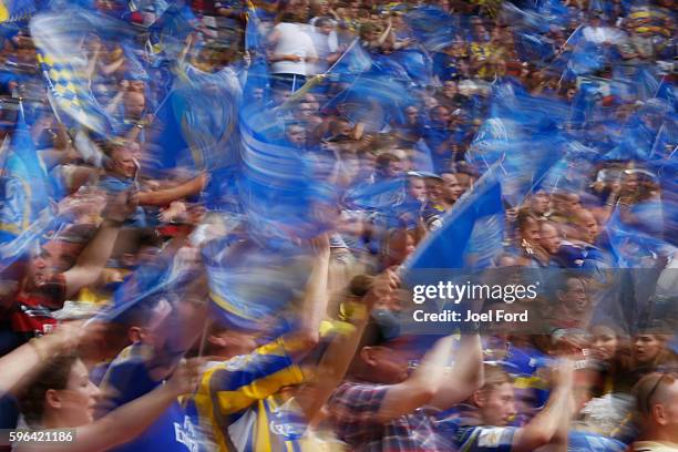 Warrington Wolves supporters cheer their team during the Ladbrokes Challenge Cup Final between Hull FC and Warrington Wolves at Wembley Stadium on...