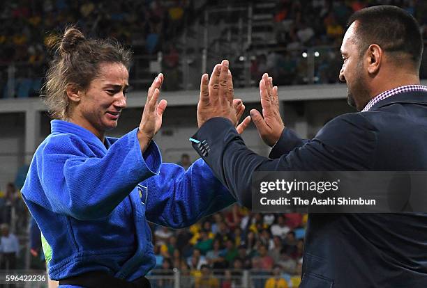 Majlinda Kelmendi of Kosovo celebrates winning the gold medal with her coach in the Women's -52kg Judo on Day 2 of the Rio 2016 Olympic Games at...