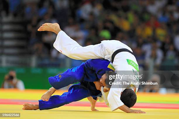 Masashi Ebinuma of Japan and Antoine Bouchard of Canada compete in the Men's -66kg bronze medal contest on Day 2 of the Rio 2016 Olympic Games at...