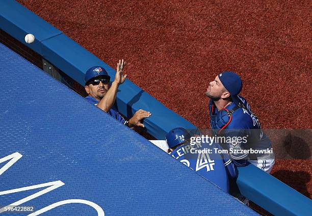 Josh Thole of the Toronto Blue Jays cannot get to a foul pop up in the first inning during MLB game action against the Minnesota Twins on August 27,...