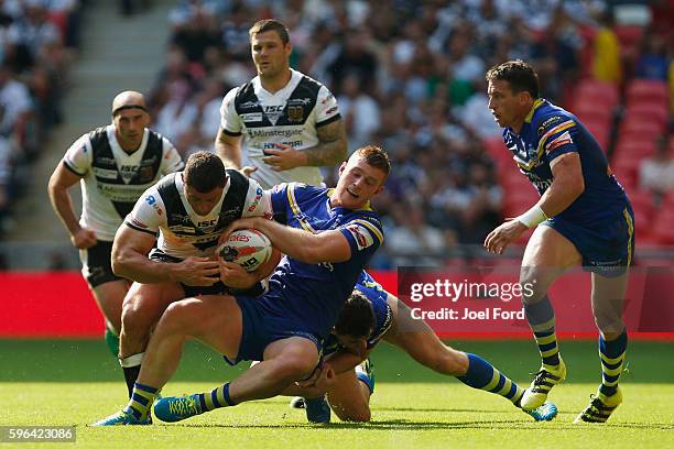 Mark Minichiello of Hull FC is tackled by Jack Hughes of the at Wembley Stadium on during the Ladbrokes Challenge Cup Final between Hull FC and...