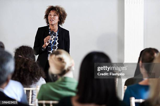 group of people at a business conference - business woman talking stock-fotos und bilder