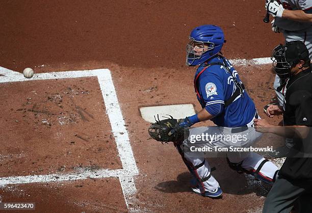 Josh Thole of the Toronto Blue Jays cannot block a wild pitch in the dirt that gets away from him in the first inning during MLB game action allowing...