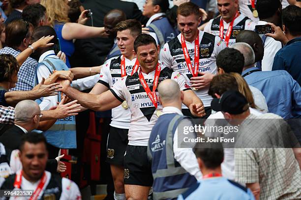 Mark Minichiello of Hull FC is congratulated by supporters after winning the Ladbrokes Challenge Cup Final between Hull FC and Warrington Wolves at...