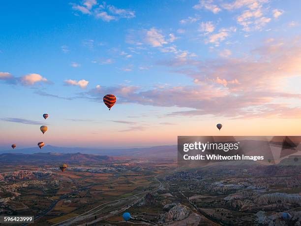 hot air balloons over cappadocia, turkey at dawn - hot air balloon basket stock pictures, royalty-free photos & images