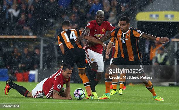 Zlatan Ibrahimovic and Paul Pogba of Manchester United in action with Jake Livermore and Tom Huddlestone of Hull City during the Premier League match...