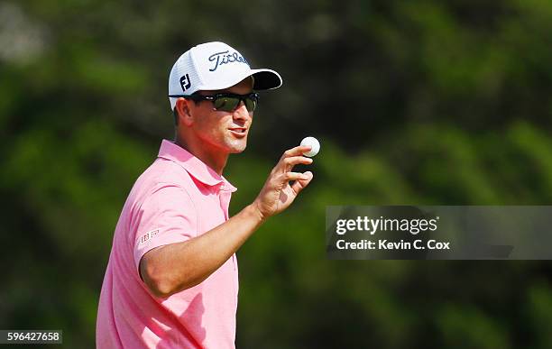 Adam Scott of Australia waves to the gallery on the 18th green after his six-under par 65 during the third round of The Barclays in the PGA Tour...