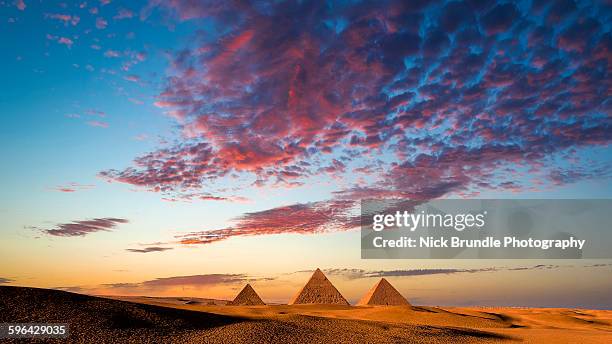 sunset at the pyramids, giza, cairo, egypt - pyramid egypt stock pictures, royalty-free photos & images